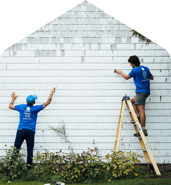 A Surv crew cleaning and painting house siding