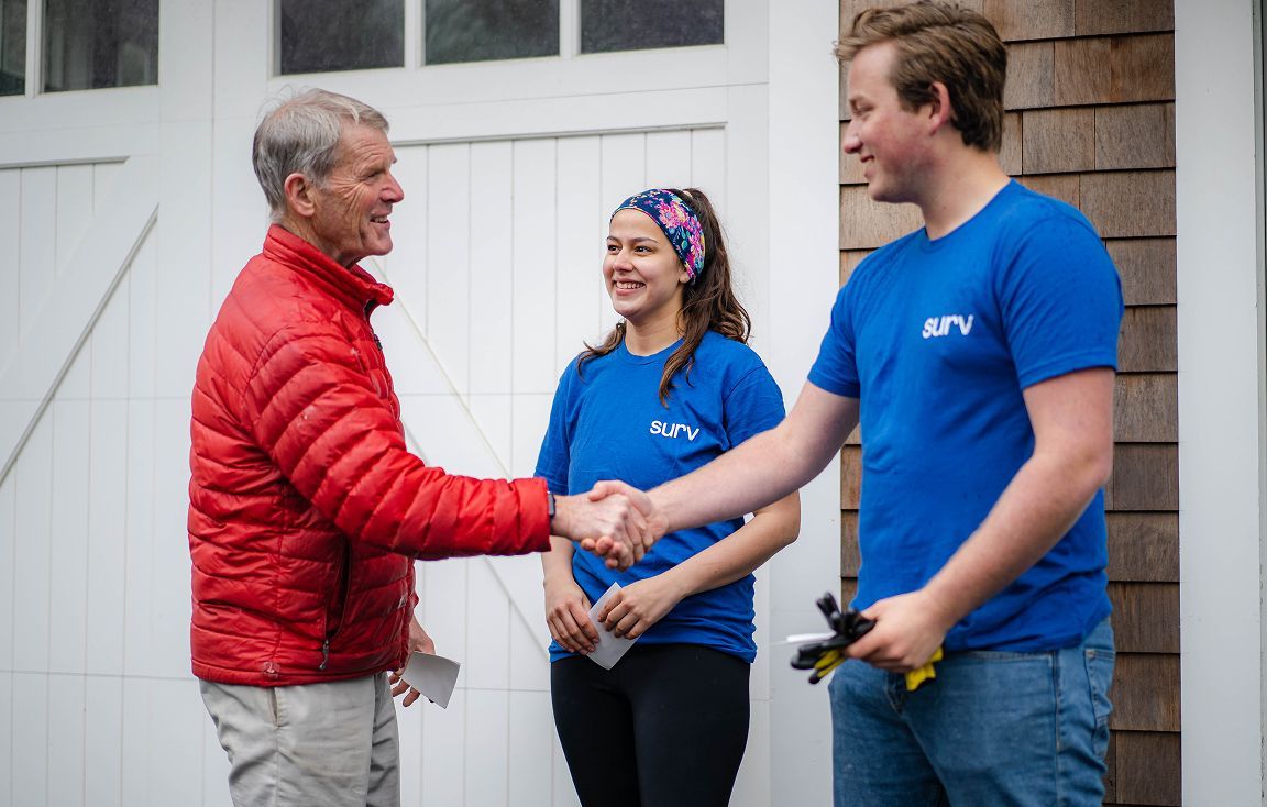 A Surv team helping an elderly client