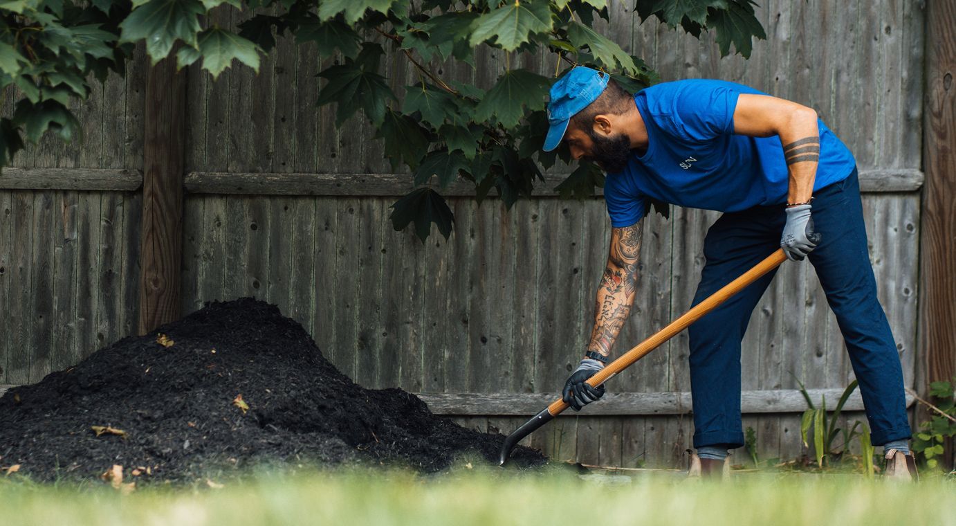 Distributing mulch around a tree
