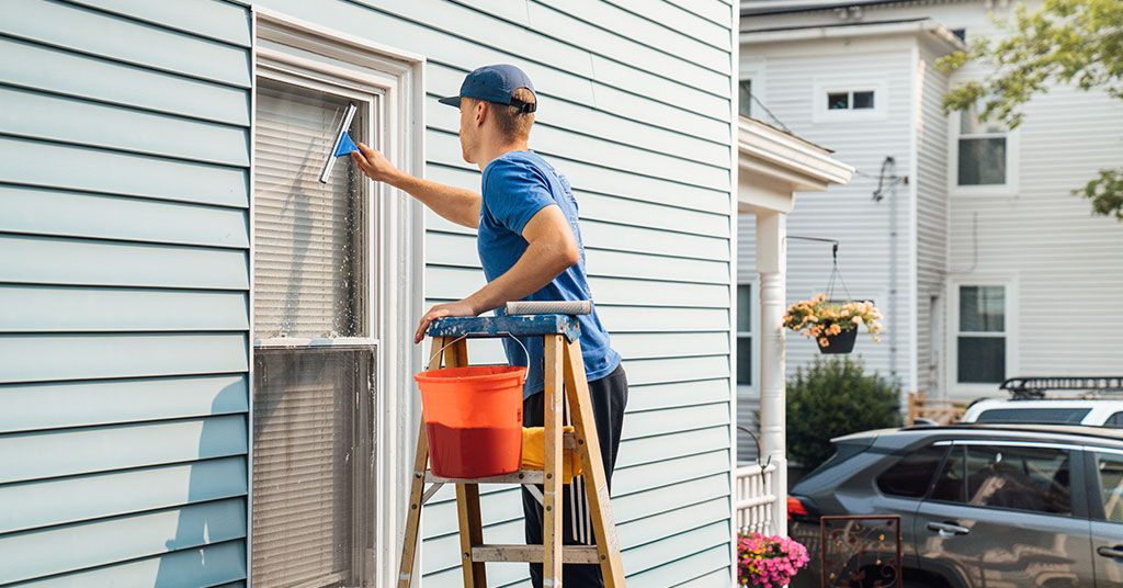 man washing a window